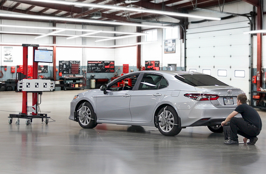 A technician performing rear camera calibration on a Toyota Camry using Tru-Point